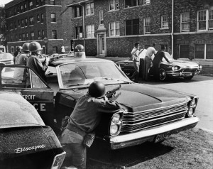 Policemen arrest suspects in a Detroit street on July 25, 1967 during riots that erupted in Detroit following a police operation. (Photo credit: Getty Images)